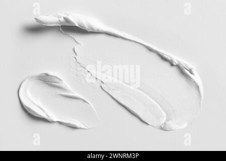 Weiße kosmetische Creme Lotion Farbschmierstoff auf weißem Hintergrund Nahaufnahme. Schlaganfall eines reichhaltigen Kosmetikprodukts. Stockfoto