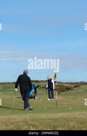 Reife Dame spielt Golf im Portpatrick Galloway Schottland, Großbritannien Stockfoto