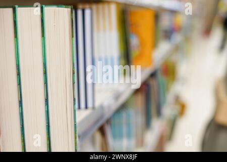 Reihen verschiedener Bücher in den Regalen des modernen urbanen Buchhandels Stockfoto