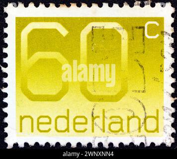 NIEDERLANDE - UM 1976: Ein in den Niederlanden gedruckter Stempel zeigt Zahlen aus gewöhnlichem Kaugummi Stockfoto