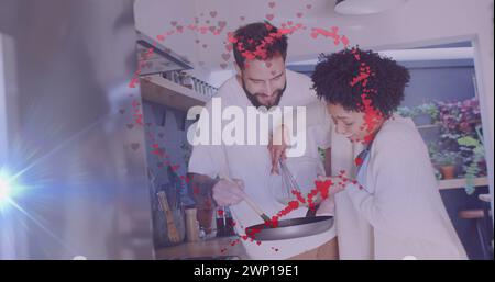 Bild von Herzen über glückliche, vielfältige Paarkochen Stockfoto