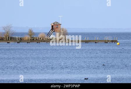 Oxford Island Nature Reserve, Lough Neagh, County Armagh, Nordirland, Großbritannien. März 2024. Wetter in Großbritannien – nach einem feuchten Start wird das Bild deutlich verbessert, da der hohe Druck mit langen Sonnenstrahlen und blauem Himmel nach der Mittagszeit anhält. Am späten Frühlingsnachmittag erleuchtet die Sonne den Landungssteg auf Oxford Island. Quelle: CAZIMB/Alamy Live News. Stockfoto