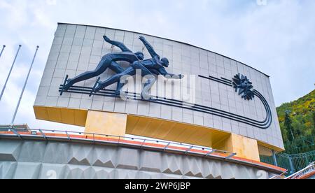 Detailansicht des Bronze-Metalllogos, -Schildes und -Symbols an der berühmten, ikonischen Eislaufbahn Medeo Chimbulak aus der Moderne der Sowjetzeit. In Almaty, Kasachsta Stockfoto