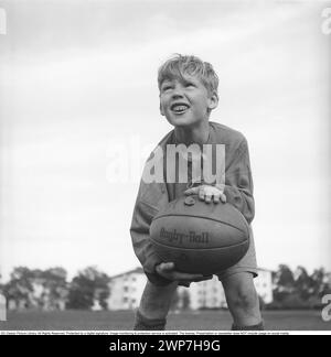 Rugby 1940. Ein junger Rugbyspieler hält den Rugbyball in den Händen. Der Rugbyball hat eine ovale Form, vier Panels und ein Gewicht von etwa 400 Gramm. 1942. Kristoffersson Ref. A56-6 Stockfoto