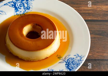 Eine Nahaufnahme eines brasilianischen Puddings, bekannt als Pudim de leite auf einem Teller Stockfoto