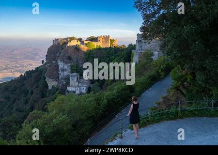 Aus der Vogelperspektive auf einen bewundernden Touristen und die Burgen von Erice. Erice, Bezirk Trapani, Sizilien, Italien. Stockfoto