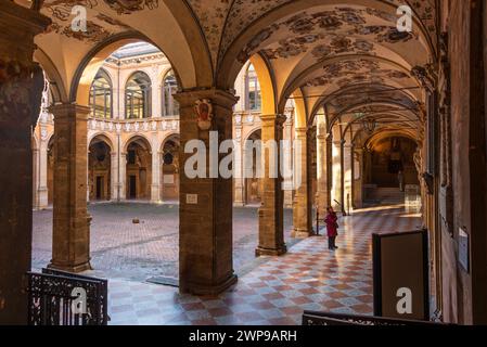 Das Kloster Archiginnasio ist ein kostbarer Innenhof in der Altstadt von Bologna, der mit vielen Wappen geschmückt ist Stockfoto