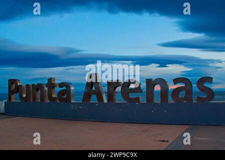 Abendlicht auf dem Punta Arenas-Schild in der Nähe des Ufers. Das Schild erinnert an 500 Jahre seit der Entdeckung der Magellan-Straße. Stockfoto