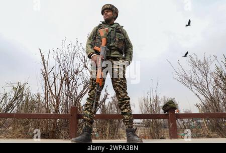 Srinagar, Indien. März 2024. Ein indischer paramilitärischer Soldat steht in der Nähe des Veranstaltungsortes, an dem der indische Premierminister Narendra Modi am 7. März zu einer öffentlichen Kundgebung sprechen soll, in Alarmbereitschaft. Vor dem ersten Besuch des indischen Premierministers Narendra Modi im Tal seit der Aufhebung des Artikels 370 im Jahr 2019 sind Sicherheitsbeamte im Kaschmir-Tal auf der Hut, wodurch der besondere halbautonome Status der Region beendet wird. (Foto: Faisal Bashir/SOPA Images/SIPA USA) Credit: SIPA USA/Alamy Live News Stockfoto