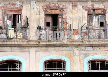 040 dreistöckiges Mietshaus in der Lamparilla Street, Old Havanna, mit gusseisernen Geländern Balkonen und Trockenwäsche. La Habana-Kuba. Stockfoto