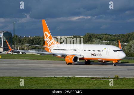 Die SkyUp Airlines Boeing 737-800 der ukrainischen Fluggesellschaft fährt zum Start am Flughafen Lemberg mit Sturmwolken im Hintergrund Stockfoto