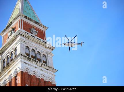 Venedig, VE, Italien - 13. Februar 2024: Glockenturm des Heiligen Markus und italienischer Polizeihubschrauber am Himmel Stockfoto