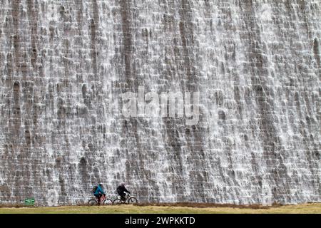 27/02/15 Radfahrer werden von Tausenden von Liter Wasser aus geschmolzenem Schnee und Tagen mit starkem Regen, der über den Derwent Dam hinunter in den Jungen fließt, in den Schatten gestellt Stockfoto