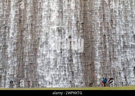 27/02/15 Radfahrer werden von Tausenden von Liter Wasser aus geschmolzenem Schnee und Tagen mit starkem Regen, der über den Derwent Dam hinunter in den Jungen fließt, in den Schatten gestellt Stockfoto