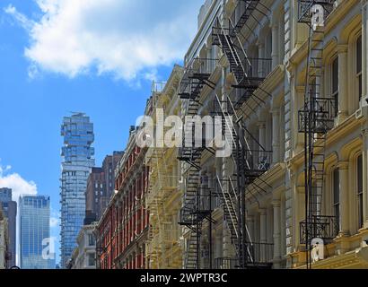 Blockbau mit externen Nottreppen, im Hintergrund Wohnturm Block 53 Leonard St Condo, SoHo Nachbarschaft, Manhattan Stockfoto