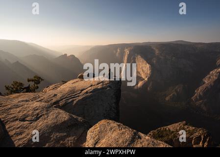 Frau am Rande einer Klippe am Taft Point in Yosemite, Kalifornien Stockfoto