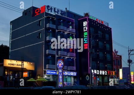 Yangyang County, Südkorea - 30. Juli 2019: Zwei sechsstöckige Motels in der Nähe von Jeongam Beach, beleuchtet mit Außenbeleuchtung, bei Nacht aufgenommen. Stockfoto