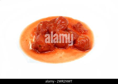 Zerstoßene Tomaten, isoliert. In Dosen geschnittene Tomaten, isoliert auf weißem Hintergrund. Tomatensauce, mit geschältem Tomatenstück, isoliert auf weiß Stockfoto