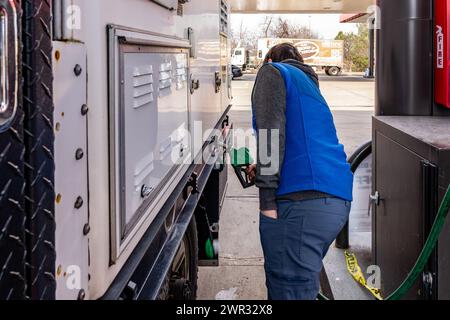 Mann, der Dieselkraftstoff in einen Lkw mit einer umweltfreundlichen Pumpe an der Tankstelle bringt. Stockfoto