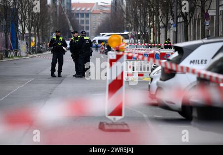 Berlin, Deutschland. März 2024. Polizeibeamte stehen am Montagmorgen am Tatort in der Zimmerstraße. Der Mann, der in der Nähe der Touristenattraktion Checkpoint Charlie in Berlin erschossen wurde, ist gestorben. Am Sonntagabend wurde er von Sanitätern ins Krankenhaus gebracht, wo er starb. Quelle: Bernd von Jutrczenka/dpa/Alamy Live News Stockfoto