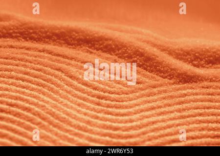 Helle funkelnde Sandwellen orange roter Ton Detailbild Hintergrund Stockfoto