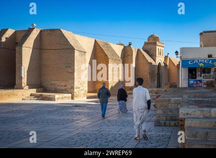 Die Menschen laufen in Richtung der 9. Großen Moschee von Kairouan, oder Moschee von Uqba, in Kairouan, Tunesien. Stockfoto