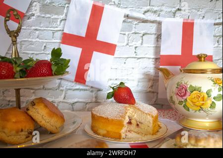 St. Georges Day Nachmittagstee Feiern mit englischer Flagge Erdbeeren und Creme Scones englischer Tee Vintage Teeparty Stockfoto