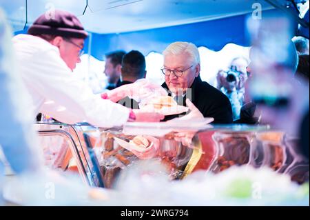 12.03.2024: Frank-Walter Steinmeier in Espelkamp - Tag 1: Der Bundespräsident macht mit fünf Jugendlichen eine Stadtführung. Er hat für drei Tage im Rahmen der 10. Ortszeit Deutschland seinen Amtssitz nach Espelkamp verlegt. Im Bild bestellt er ein Fischbrötchen auf dem Wochenmarkt. , *** 12 03 2024 Frank Walter Steinmeier in Espelkamp Tag 1 der Bundespräsident nimmt fünf Jugendliche mit auf eine Stadtbesichtigung Er hat im Rahmen der 10 Ortszeit Deutschland seinen Amtssitz für drei Tage nach Espelkamp verlegt, auf dem Bild bestellt er einen Fisch Sandwich auf dem Wochenmarkt , Stockfoto