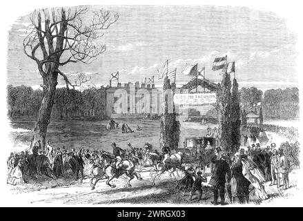 Heiratsfeiern im Quiddenham Park, Norfolk, dem Sitz des Earl of Albemarle, 1864. "Quiddenham... war der Schauplatz glücklicher Feierlichkeiten am Mittwoch, anlässlich der Hochzeit von Lady Louisa Keppel, der Tochter des Earls, mit dem Hr. Frederick William Charteris, Commander, R.N.... gegen vier Uhr verließ das glückliche Paar den Saal in einer Kutsche und vier. Sie wurden mit den herzlichen Beschwörungen einer großen Anzahl von Personen begrüßt, die im Park versammelt waren...Flaggen flogen vom Dach des Herrenhauses und an jedem immergrünen Bogen... in der Kutschenfahrt vom Saal zur Kirche dort Stockfoto
