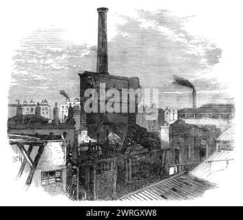 Ruinen der Patent Steam Wheel-Works, Pimlico, [London], zerstört durch Feuer, 1864. Gravur von einem Foto von Mr. A. Bool. "Die so zerstörten Gebäude, bestehend aus drei Maschinenhäusern mit ihren Kesselhäusern, und der größte Teil der Werkstätten und Lagerhäuser für den Bestand, bildeten eine sehr umfangreiche Reihe von Gebäuden, die eine Fläche von mehr als zwei Hektar einnahmen und eine Fassade mit Eingangstoren im unteren Belgrave-Platz hatten. Sie wurden durch den hohen Schacht eines gemauerten Schornsteins deutlich, der weit über den umliegenden Häusern aufragte. Es ist wirklich ein Glück, dass der hohe Schornstein in Dosen nicht war Stockfoto