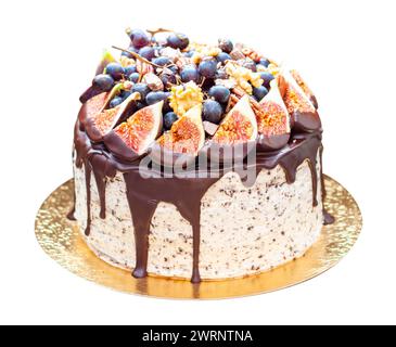 Köstlicher Kuchen mit Früchten, getaucht in geschmolzene Schokolade, Pekannüsse, Trauben, Schokoladenbissen und Kekse. Konzept der Herbst- oder Sommerernte Stockfoto
