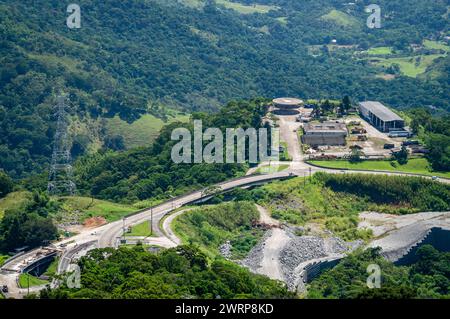 Aus der Vogelperspektive auf die Umgebung des Washington Luiz Highway (BR-040) voller grüner Vegetation im Atlantischen Wald rund um den Sommernachmittag sonnigen Tag. Stockfoto