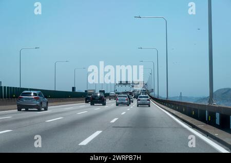 Starke Verkehrsbewegung über die Rio Niteroi-Brücke (Mario Covas Highway) bei KM 329 während der Fahrt nach Niteroi-Stadt unter dem sonnigen blauen Himmel am Sommernachmittag. Stockfoto