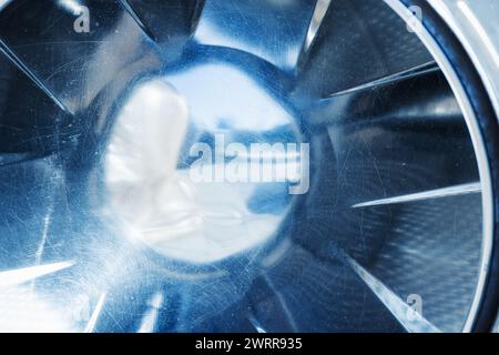 Eine leere Waschmaschinentrommel aus Edelstahl mit abstrakter industrieller Hintergrundstruktur Stockfoto