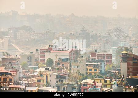 Blick auf Kathmandu Hauptstadt von Nepal vom Berg durch urbanes Dunst mit vielen flachen Gebäuden, die Stadtlandschaft schafft eine ätherische Atmosphäre im Berg Stockfoto