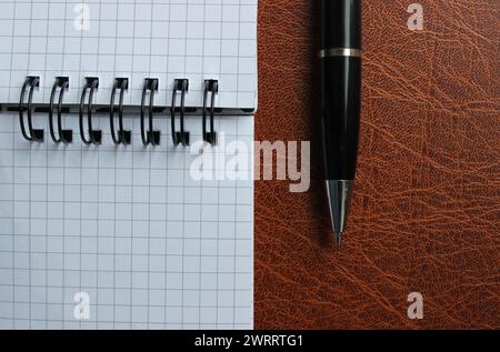 Binder-Notizblock mit weißen Seiten und geöffnetem Stift auf Einem Lederordner Stock Photo für Titel oder Geschäftslogo Stockfoto