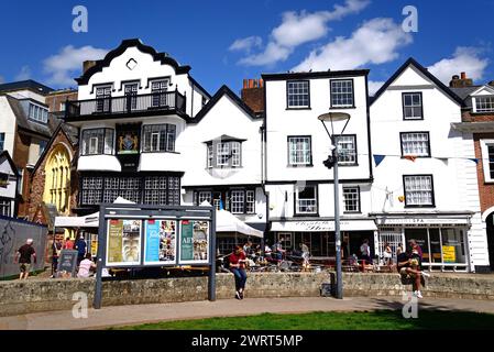 Vorderansicht der Mols und anderer Gebäude in der Kathedrale in der Nähe mit einem Straßencafé im Vordergrund, Exeter, Devon, Großbritannien, Europa. Stockfoto