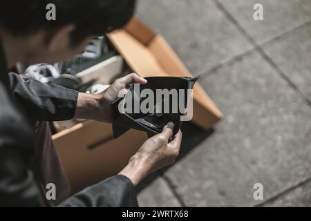 Mitarbeiter, die aus dem Unternehmen entlassen oder zurückgetreten sind, öffnen ihre Geldbörsen, um Münzen zu sehen. Arbeitslos, Einstellung, Kündigung des Arbeitsplatzes Konzept. Stockfoto