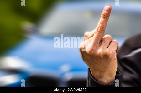 Der Stinkefinger ist eine bekannte, aber nicht freundlich, Geste. Hier von einem jungen Mann gezeigt. (Wil ZH, Schweiz, 20.05.2023) Stockfoto