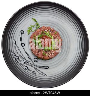 Thunfisch und Avocadotartar auf einer dunklen Keramikplatte Stockfoto