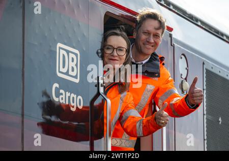 15. März 2024, Sachsen-Anhalt, Halle (Saale): Sigrid Nikutta, CEO von DB Cargo, und Michael Peter, Geschäftsführer von Siemens Mobility, stehen in einer neuartigen Hybridlokomotive auf dem Güterbahnhof. Künftig wird die neue Generation von Triebwerken rein elektrisch auf elektrifizierten Gleisabschnitten betrieben, während auf Abschnitten ohne Freileitungen ohne Wechsel der Lokomotiven auf konventionellen Antrieb umgeschaltet werden kann. Die Hybridlokomotiven, die Vectron Dual Mode Light genannt werden, werden vom Bahnanbieter Siemens Mobility hergestellt. Wenn die Lokomotive mit Ökostrom betrieben wird, A Stockfoto