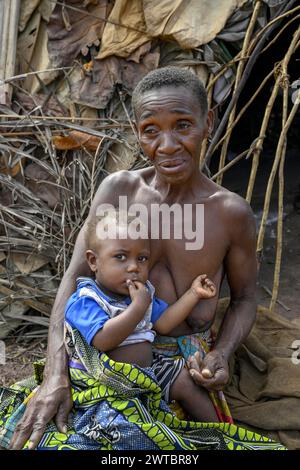 Zwergfrau der Baka oder BaAka mit ihrem Kind vor ihrer Hütte, Bayanga, Präfektur Sangha-Mbaere, Zentralafrikanische Republik Stockfoto