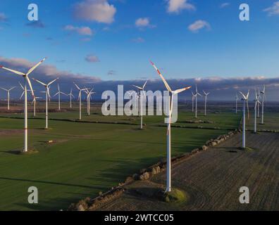 Petersdorf, Deutschland. März 2024. Die niedrige Abendsonne scheint auf die Windräder des Windparks „Odervorland“ (Luftbild mit einer Drohne aufgenommen). Quelle: Patrick Pleul/dpa/Alamy Live News Stockfoto