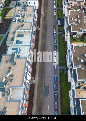 Eine obere, vertikale Ansicht einer modernen Straße in einem Apartmentkomplex mit Fahrradwegen und Straßen und Parkplätzen für PKW, sind städtisch Stockfoto