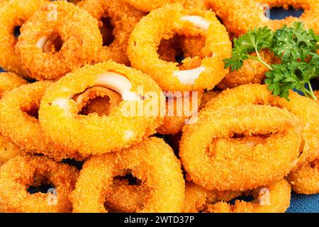 Gebackene panierte Calamari-Ringe, serviert mit Limette. Hintergrund zu Lebensmitteln. Stockfoto