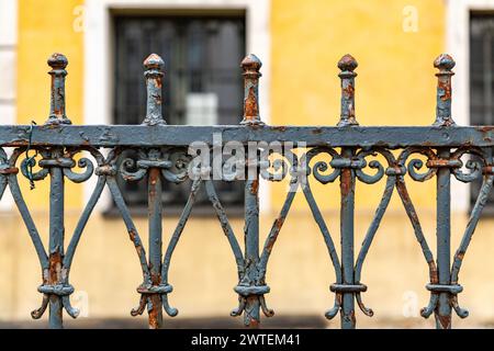 Grün lackierte schmiedeeiserne Zäune aus nächster Nähe, Details von Zaunstäben im Vintage-Stil Stockfoto