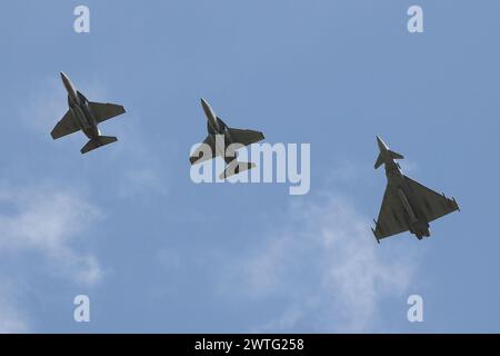 Drei italienische Luftwaffenjets fliegen über die RAF Fairford in Gloucestershire, England, kurz bevor sie an der Royal International Air Tattoo 2023 teilnehmen. Das Trio bestand aus zwei Leonardo T-346A Masters (CSX55223 und MM55224) und einem Eurofighter F-2000A Typhoon (CSX7352). Stockfoto