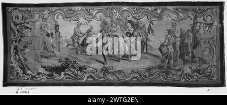 Tanzen. Teniers, David II (Flämisch, 1610-1690) (Design After) [Maler] unbekannter Gobelin Abmessungen: H 6'2' x B 28' Gobelin Materialien/Techniken: Unbekannt Kultur: Flämisches Weberzentrum: Brüssel Besitz Geschichte: Französisch & Co. In der Landschaft tanzen und Hände halten (Mitte); der Musiker, der auf einer umgedrehten Wanne steht, spielt Dudelsack zu Schlagzeuger; das Paar betritt das Gebäude (BRD) simuliert einen geschnitzten Rahmen mit Teniers-Design. French & Co. Lagerbogen fehlt im Archiv, 13387 Stockfoto