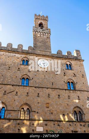 Fassade des mittelalterlichen Palazzo dei priori, erbaut im 13. Jahrhundert, Heimat der Gemeindeämter und Wechselausstellungen, mit Uhr und Turm, Volterra Stockfoto