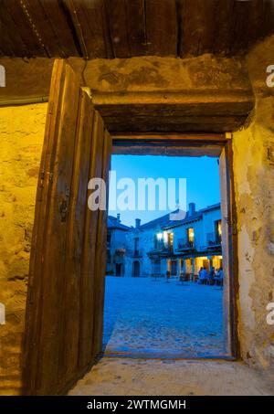 Hauptplatz durch eine offene Tür, Blick auf die Nacht. Pedraza, Provinz Segovia, Castilla Leon, Spanien. Stockfoto